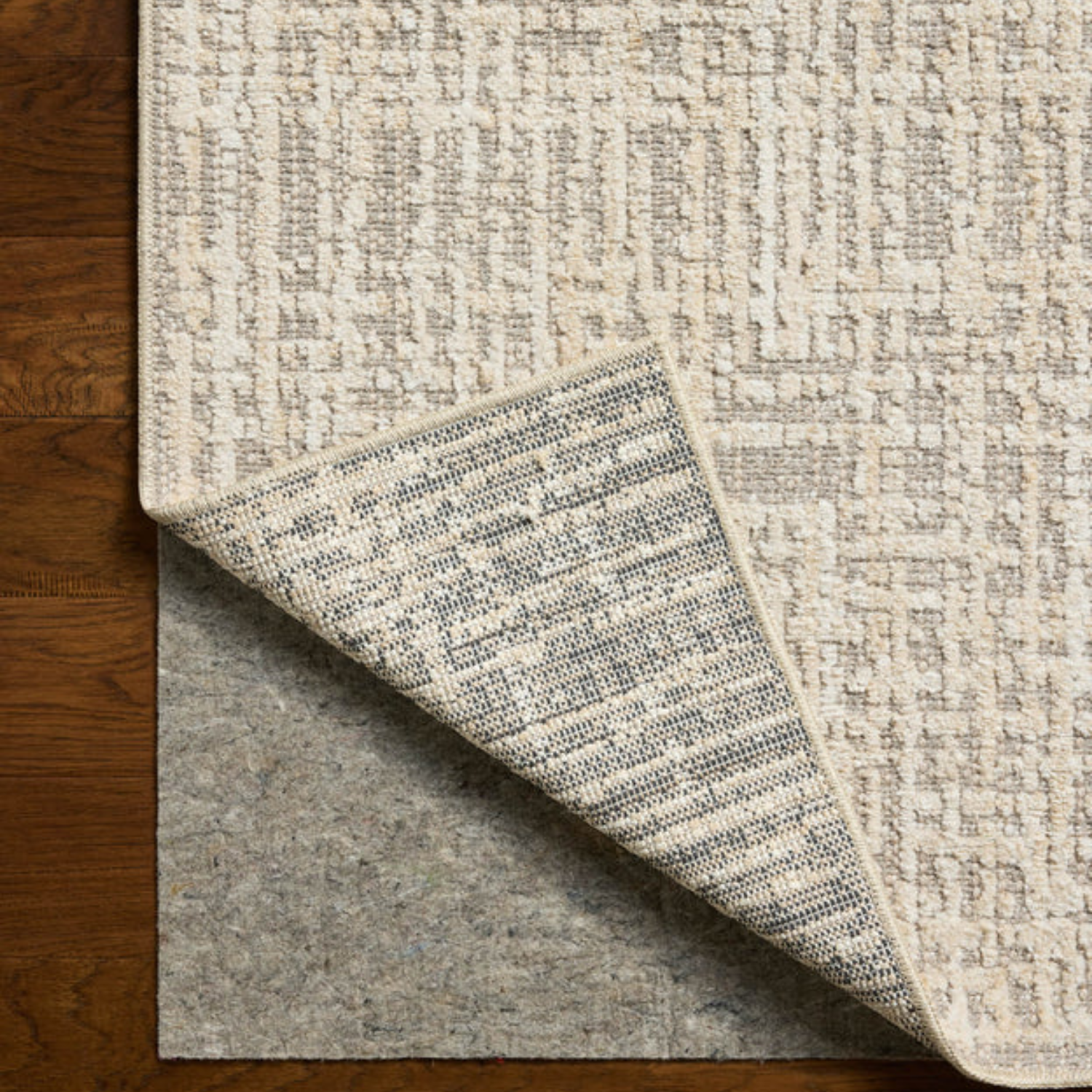 Edge and backing detail of Homvirex Bexley Natural Dove rug