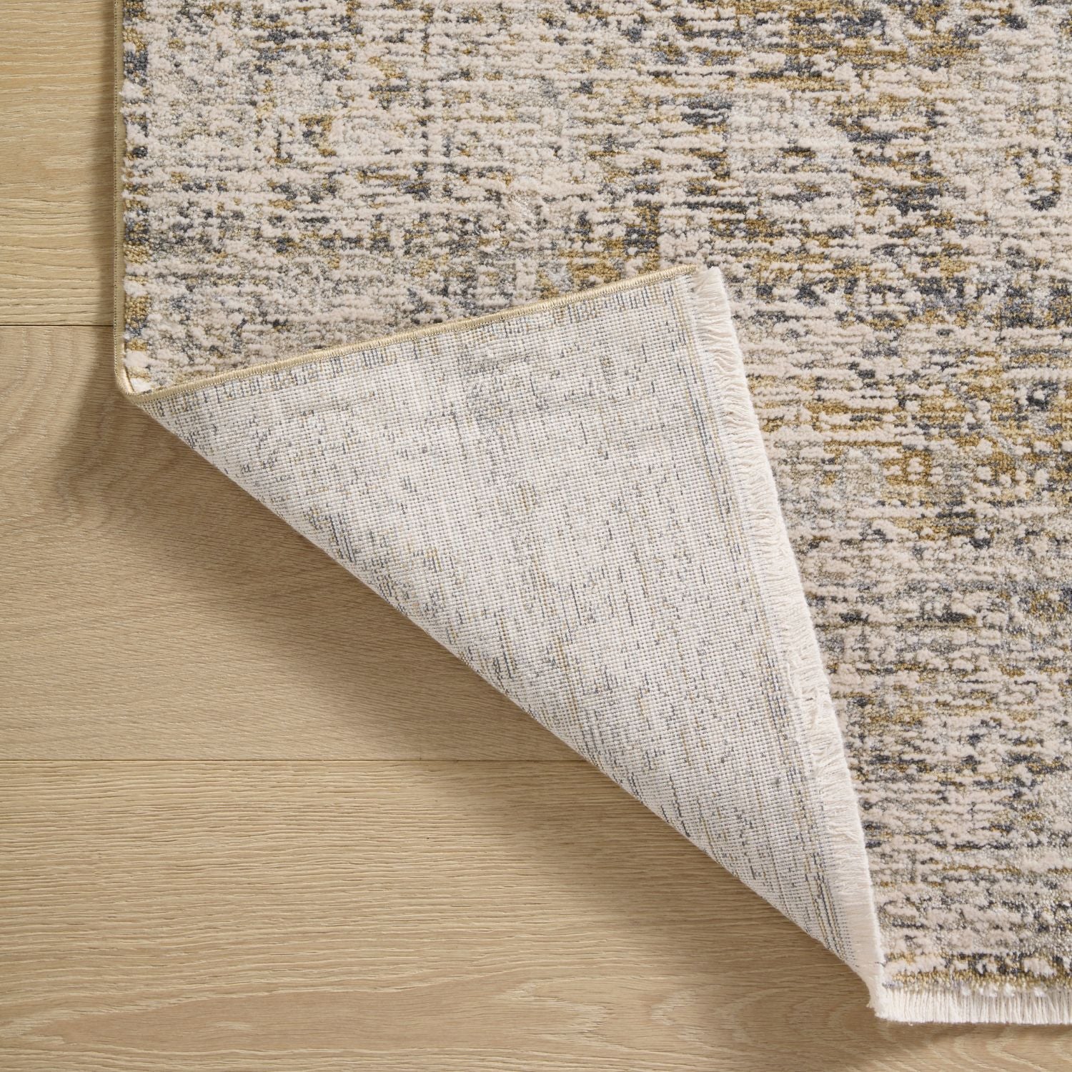 Edge and backing detail of Homvirex Alie Gold Beige rug